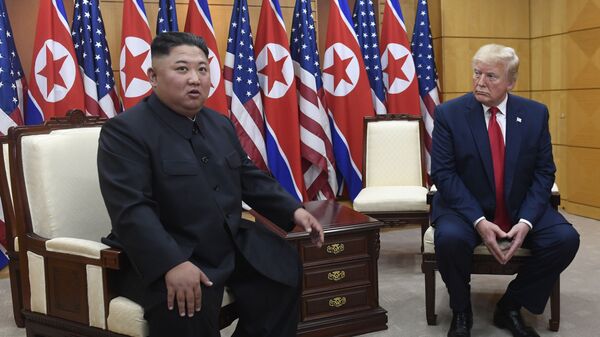  In this June 30, 2019, file photo President Donald Trump, right, listens as North Korean leader Kim Jong Un, left, speaks during their bilateral meeting inside the Freedom House at the border village of Panmunjom in the Demilitarized Zone, South Korea - Sputnik International