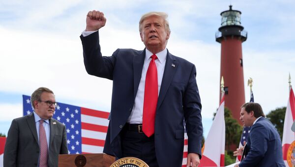 US President Donald Trump pumps his fist at the crowd after signing an extension of the ban on offshore drilling off the coast of the state of Florida in front of a crowd of Trump supporters as US Environmental Protection Agency Director Andrew Wheeler and Florida Governor Ron DeSantis look on in Jupiter, Florida, U.S. September 8, 2020 - Sputnik International