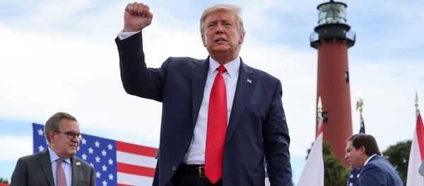 US President Donald Trump pumps his fist at the crowd after signing an extension of the ban on offshore drilling off the coast of the state of Florida in front of a crowd of Trump supporters as US Environmental Protection Agency Director Andrew Wheeler and Florida Governor Ron DeSantis look on in Jupiter, Florida, U.S. September 8, 2020 - Sputnik International