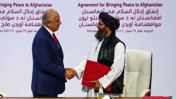 Mullah Abdul Ghani Baradar, the leader of the Taliban delegation, and Zalmay Khalilzad, U.S. envoy for peace in Afghanistan, shake hands after signing an agreement at a ceremony between members of Afghanistan's Taliban and the U.S. in Doha, Qatar February 29, 2020.  - Sputnik International