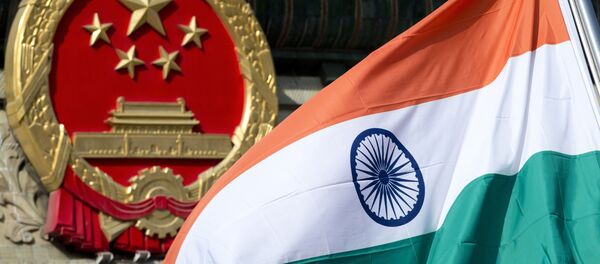 In this Oct. 23, 2013, file photo, an Indian national flag is flown next to the Chinese national emblem outside the Great Hall of the People in Beijing. China’s Commerce Ministry said Thursday, Aug. 13, 2020 it has extended punitive tariffs on Indian optical fiber products for five years. The announcement follows a yearlong review after a previous tariff expired in 2019 - Sputnik International