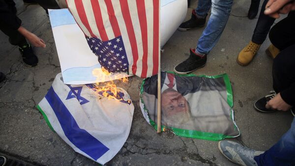 Lebanese and Palestinians students, burn a picture of U S. President Donald Trump, an American flag and an Israeli flag, as they take part in a protest at the Lebanese University, in the southern port city of Sidon, Lebanon, Thursday, Dec. 7, 2017, against U.S. President Donald Trump's decisions to recognize Jerusalem as the capital of Israel. - Sputnik International