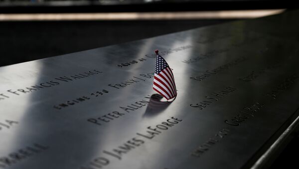 A US flag is placed on one of the victims' names at the south reflecting pool of the National 9/11 Memorial, two days before the 19th anniversary of attacks, amid the coronavirus disease (COVID-19) pandemic, in the lower section Manhattan, New York City, US, September 9, 2020 - Sputnik International
