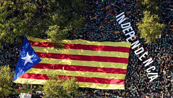 An aerial view of people waving a giant Catalan pro-independence Estelada flag during a demonstration marking the Diada, national day of Catalonia, in Barcelona on September 11, 2019.  - Sputnik International