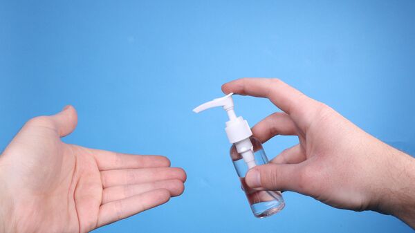 Man hand using wash hand sanitizer gel. - Sputnik International