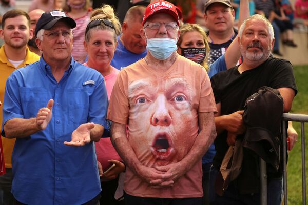 Supporters, one wearing a shirt with US President Donald Trump's face, react as Trump speaks during a campaign event at Smith Reynolds Regional Airport in Winston-Salem, North Carolina, US, September 8, 2020 - Sputnik International