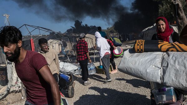 Migrants near the burned-out Moriah migrant camp on Lesbos, Greece - Sputnik International