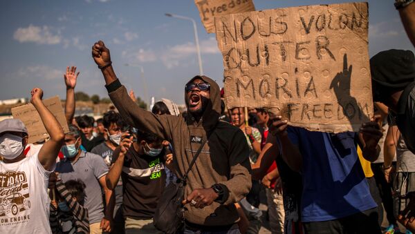 Refugees and migrants from the Moria camp protest near Mytilene on the Greek island of Lesbos, on September 12, 2020, a few days after a fire destroyed the Moria refugee camp - Sputnik International