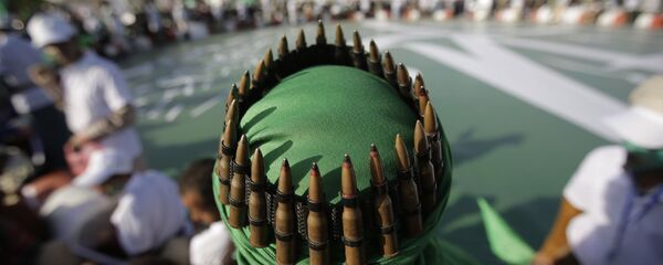 A supporter of Shiite rebels, known as Houthis, with an ammunition belt placed on his head attends a celebration of Moulid al-nabi, the birth of Islam's prophet Muhammad in Sanaa, Yemen, Saturday, Nov. 9, 2019 - Sputnik International