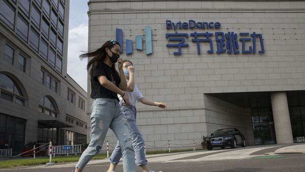 Women wearing masks to prevent the spread of the coronavirus chat as they pass by the ByteDance headquarters in Beijing, China on Friday, Aug. 7, 2020. President Donald Trump on Thursday ordered a sweeping but unspecified ban on dealings with the Chinese owners of consumer apps TikTok and WeChat, although it remains unclear if he has the legal authority to actually ban the apps from the U.S. TikTok is owned by Chinese company ByteDance - Sputnik International