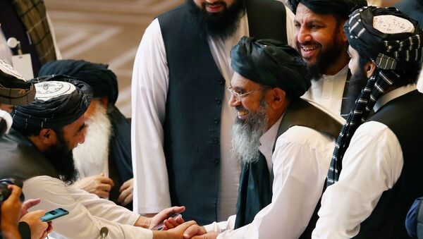 Taliban delegates shake hands during talks between the Afghan government and Taliban insurgents in Doha, Qatar September 12, 2020 - Sputnik International