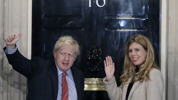 FILE -In this Friday, Dec. 13, 2019 file photo, Britain's Prime Minister Boris Johnson and his partner Carrie Symonds wave from the steps of number 10 Downing Street in London. - Sputnik International