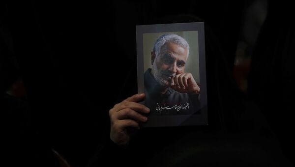 A Hezbollah supporter holds pictures of slain Iranian Revolutionary Guard Gen. Qassem Soleimani during a ceremony marking the anniversary of the assassination of Hezbollah leaders, Abbas al-Moussawi, Ragheb Harb and Imad Mughniyeh and the end of a 40-day Muslim mourning period for Soleimani, in the southern suburb of Beirut, Lebanon, Sunday, Feb. 16, 2020 - Sputnik International