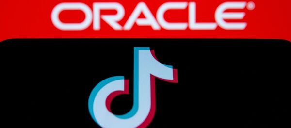 A smartphone with the Tik Tok logo is seen in front of a displayed Oracle logo in this illustration taken, Septemeber 14, 2020. REUTERS/Dado Ruvic/Illustration A smartphone with the Tik Tok logo is seen in front of a displayed Oracle logo in this illustration taken, Septemeber 14, 2020. REUTERS/Dado Ruvic/Illustration - Sputnik International