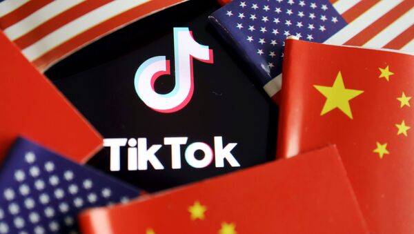 China and U.S. flags are seen near a TikTok logo in this illustration picture taken July 16, 2020. REUTERS/Florence Lo/Illustration - Sputnik International