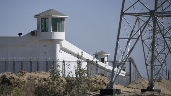 This file photo taken on May 30, 2019 shows watchtowers on a high-security facility near what is believed to be a re-education camp where mostly Muslim ethnic minorities are detained, on the outskirts of Hotan, in China's northwestern Xinjiang region. - The US announced September 14, 2020 it would block a range of Chinese products made by forced labor in the Xinjiang region, including from a vocational center that it branded a concentration camp for Uighur minorities. - Sputnik International