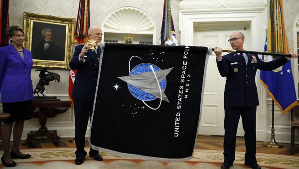 Chief of Space Operations at US Space Force Gen. John Raymond, center, and Chief Master Sgt. Roger Towberman, right, hold the United States Space Force flag as it is presented in the Oval Office of the White House, Friday, May 15, 2020, in Washington.  Secretary of the Air Force Barbara Barrett stands far left. - Sputnik International