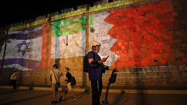 The flags of Israel, United Arab Emirates, and Bahrain are projected on the ramparts of Jerusalem's Old City on September 15, 2020 in a show of support for Israeli normalisation deals with the United Arab Emirates and Bahrain - Sputnik International