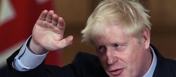 Britain's Prime Minister Boris Johnson reacts during a virtual press conference at Downing Street in London, Wednesday Sept. 9, 2020, following the announcement that the legal limit on social gatherings is set to be reduced from 30 people to six. Britain's Prime Minister Boris Johnson reacts during a virtual press conference at Downing Street in London, Wednesday Sept. 9, 2020, following the announcement that the legal limit on social gatherings is set to be reduced from 30 people to six. - Sputnik International
