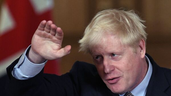 Britain's Prime Minister Boris Johnson reacts during a virtual press conference at Downing Street in London, Wednesday Sept. 9, 2020, following the announcement that the legal limit on social gatherings is set to be reduced from 30 people to six.  - Sputnik International