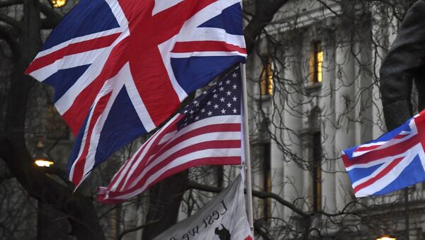 In this file photo dated Friday, Jan. 31, 2020, Brexit supporters hold British and US flags during a rally in London - Sputnik International
