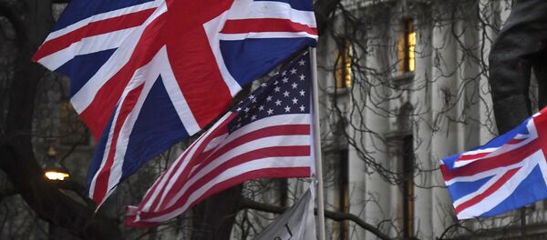 In this file photo dated Friday, Jan. 31, 2020, Brexit supporters hold British and US flags during a rally in London - Sputnik International