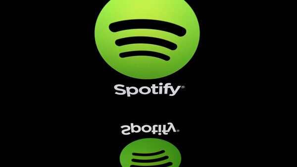 This combination created on March 13, 2019 of file illustrations displayed on tablet screens shows the logo of the US multinational technology company Apple (bottom, February 18, 2019 in Paris) and the logo of online streaming music service Spotify (April 19, 2018 in Paris). - Swedish music streaming giant Spotify said on March 13, 2019 it had filed a formal complaint with the EU Commission against Apple, accusing its US rival of stifling competition in the online music market. - Sputnik International
