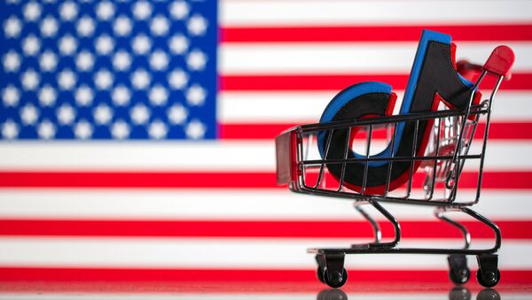 A shopping trolley carries a 3D printed Tik Tok logo is seen in front of displayed U.S. flag in this illustration taken September 18, 2020 - Sputnik International