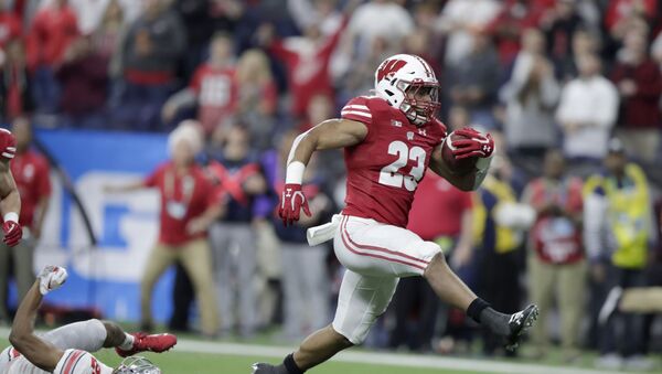 FILE - In this Dec. 7, 2019, file photo, Wisconsin running back Jonathan Taylor (23) runs for a touchdown past Ohio State cornerback Shaun Wade (24) during the first half of the Big Ten championship NCAA college football game, in Indianapolis. Taylor was selected to The Associated Press All-Big Ten Conference team, Wednesday, Dec. 11, 2019. (AP Photo/Michael Conroy, File) - Sputnik International