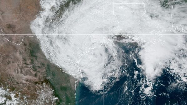This GOES-16 GeoColor satellite image taken Monday, Sept. 21, 2020, and provided by NOAA, shows Tropical Storm Beta, center, in the Gulf of Mexico. - Sputnik International
