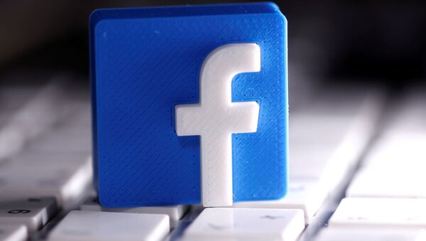A 3D-printed Facebook logo is seen on a keyboard in this illustration taken March 25, 2020. - Sputnik International