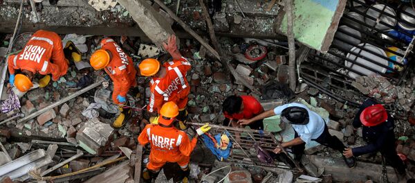 National Disaster Response Force (NDRF) officials and firemen remove debris as they look for survivors after a three-storey residential building collapsed in Bhiwandi on the outskirts of Mumbai, India, September 21, 2020. National Disaster Response Force (NDRF) officials and firemen remove debris as they look for survivors after a three-storey residential building collapsed in Bhiwandi on the outskirts of Mumbai, India, September 21, 2020. - Sputnik International