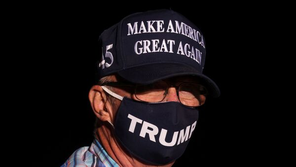A man wearing a Make America Great Again hat attends U.S. President Donald Trump's campaign rally in Reno, Nevada, U.S., September 12, 2020. - Sputnik International