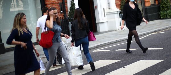 A woman wears a protective face mask as she walks on a street, amid the spread of the coronavirus disease (COVID-19) in Chelsea, London, Britain September 22, 2020 A woman wears a protective face mask as she walks on a street, amid the spread of the coronavirus disease (COVID-19) in Chelsea, London, Britain September 22, 2020 - Sputnik International