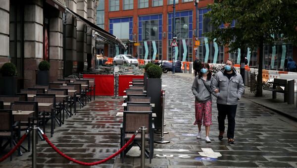 FILE PHOTO: People wearing protective masks walk as the city and surrounding areas face local restrictions in an effort to avoid a local lockdown being forced upon the region, amid the coronavirus disease (COVID-19) outbreak, in Manchester, Britain August 4, 2020 - Sputnik International