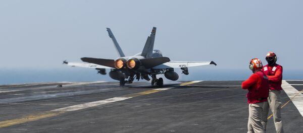 An F/A-18C Hornet, from the “Death Rattlers” of Marine Fighter Attack Squadron (VMFA) 323, launches from the flight deck of the aircraft carrier USS Nimitz (CVN 68) in support of Operation Inherent Resolve.  - Sputnik International