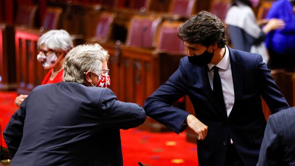 Canada's Prime Minister Justin Trudeau greets a Senator with an elbow-bump prior to the Throne Speech in the Senate, as parliament prepares to resume in Ottawa, Ontario, Canada September 23, 2020. - Sputnik International