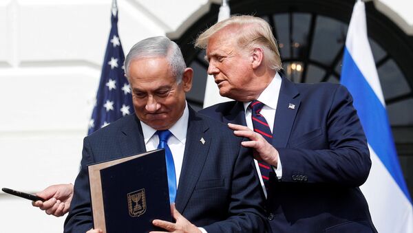 Israel's Prime Minister Benjamin Netanyahu stands with U.S. President Donald Trump after signing the Abraham Accords, normalizing relations between Israel and some of its Middle East neighbors,  in a strategic realignment of Middle Eastern countries against Iran, on the South Lawn of the White House in Washington, U.S., September 15, 2020 - Sputnik International