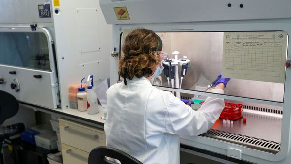 A scientist works during the visit of Britain's William, Duke of Cambridge, to the manufacturing laboratory where a vaccine against the coronavirus disease (COVID-19) has been produced at the Oxford Vaccine Group's facility at the Churchill Hospital in Oxford, Britain, 24 June 2020 - Sputnik International