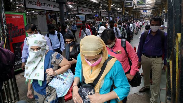 People wearing protective face masks leave the Chhatrapati Shivaji Terminus railway station, amidst the coronavirus disease (COVID-19) outbreak, in Mumbai, India, 22 September 2020 - Sputnik International