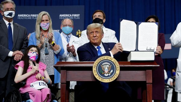U.S. President Donald Trump displays an executive order he signed at a campaign event on healthcare at Charlotte Douglas International Airport in Charlotte, North Carolina, U.S., September 24, 2020. - Sputnik International
