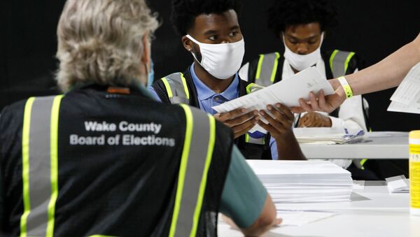 Poll workers prepare absentee ballots for shipment at the Wake County Board of Elections on the first day that the state started mailing them out, in Raleigh, North Carolina, U.S. September 4, 2020.  - Sputnik International