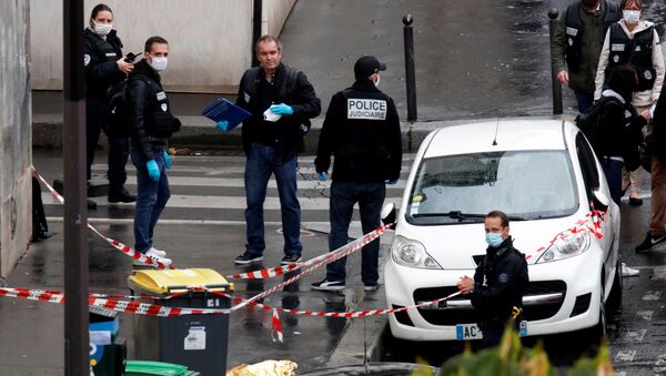 Police officers investigate the scene of an incident near the former offices of French magazine Charlie Hebdo, in Paris, France September 25, 2020 - Sputnik International