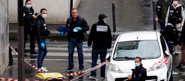 Police officers investigate the scene of an incident near the former offices of French magazine Charlie Hebdo, in Paris, France September 25, 2020 - Sputnik International