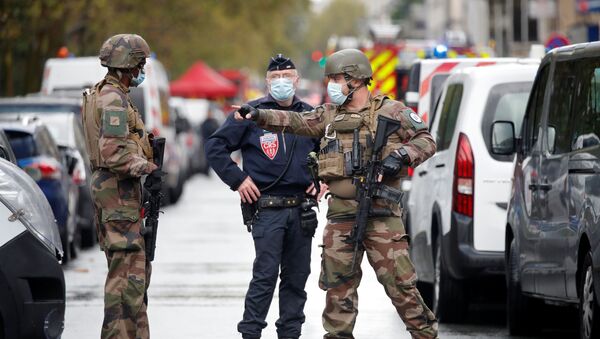 Security forces guard the scene of an incident near the former offices of French magazine Charlie Hebdo, in Paris, France September 25, 2020 - Sputnik International