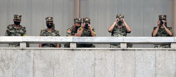 North Korean soldiers keep watch toward the south as South Korean Unification Minister Lee In-young inspects (not pictured) the truce village of Panmunjom inside the demilitarised zone separating the two Koreas, South Korea, 16 September 2020. - Sputnik International