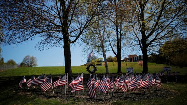 U.S. flags are planted outside the Soldiers Home for the 88 veteran residents who have died during the coronavirus disease (COVID-19) outbreak in Holyoke, Massachusetts, U.S., May 13, 2020.  - Sputnik International