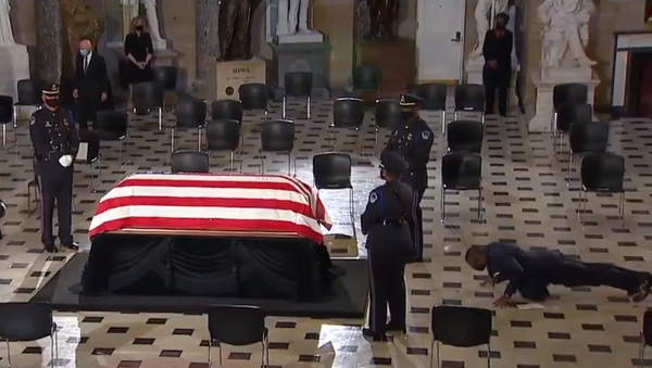 Screenshot from a video showing personal trainer of Justice Ruth Bader Ginsburg doint push-ups in her memory while standing in front of her casket during the memorial service in US Capitol - Sputnik International