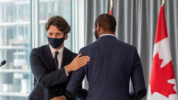 Canada's Prime Minister Justin Trudeau pats member of parliament Greg Fergus, after unveiling plans for post-coronavirus recovery for Black owned business and entrepreneurs in Toronto, Ontario, Canada September 9, 2020. - Sputnik International