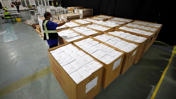 An election worker surveys thousands of absentee ballots awaiting preparation at the Wake County Board of Elections on the first day that the state started mailing out absentee ballots, in Raleigh, North Carolina, U.S. September 4, 2020.  - Sputnik International